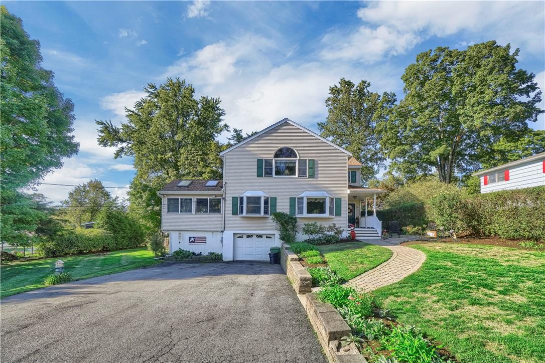 1 Mid Oaks Road Monroe, NY 10950 - Photo 1 of 1 a front view of a house with a yard and potted plants
