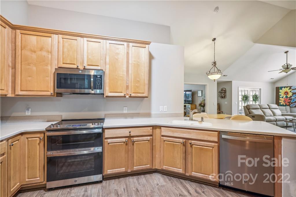 860 Ledgestone Court Tega Cay, SC 29708 - Photo 23 of 37 a kitchen with stainless steel appliances granite countertop a sink and cabinets