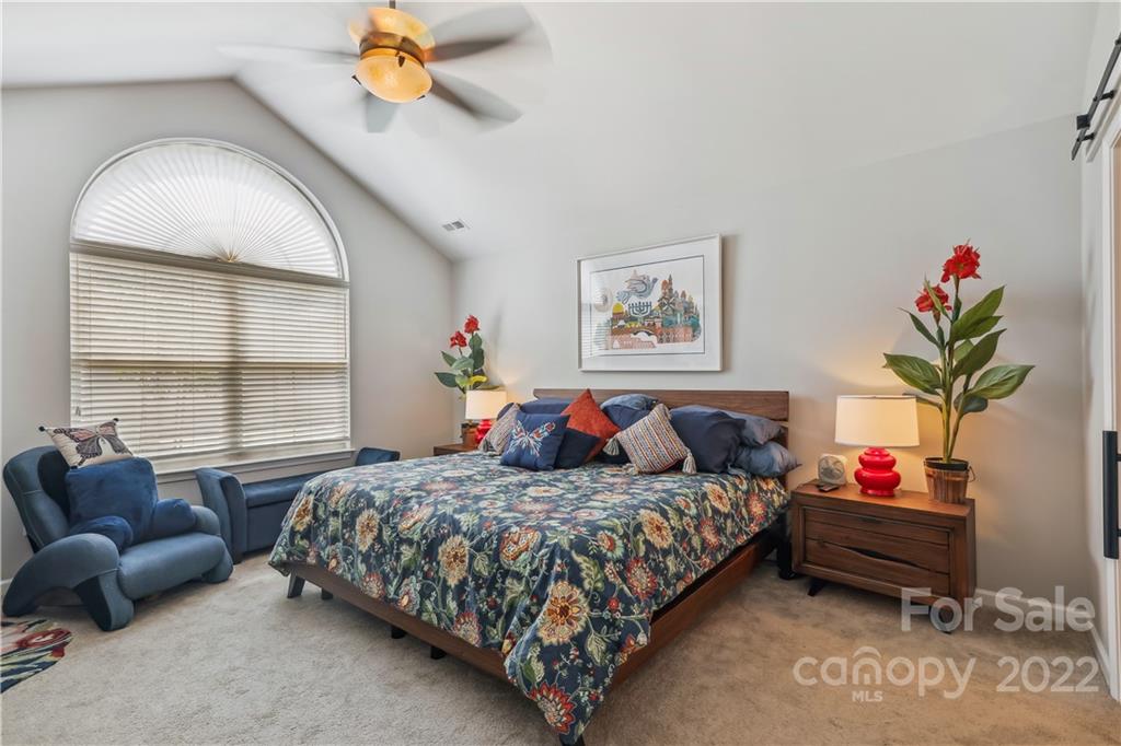 860 Ledgestone Court Tega Cay, SC 29708 - Photo 28 of 37 a bedroom with bed and a chandelier