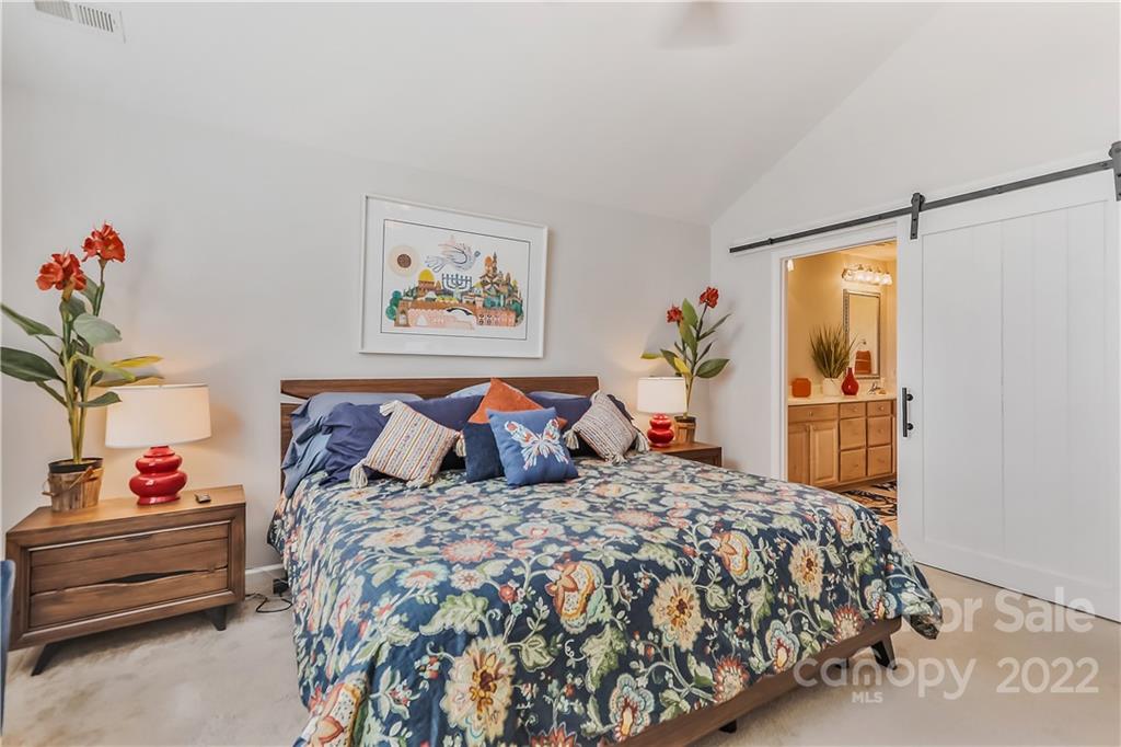 860 Ledgestone Court Tega Cay, SC 29708 - Photo 29 of 37 a bed room with a bed and a couch