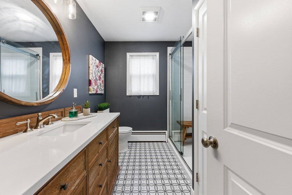 26 Prospect Street Blackstone, MA 01504 - Photo 12 of 41 a bathroom with a sink a toilet a mirror and shower