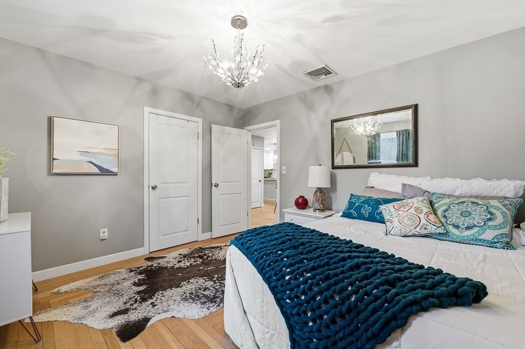 26 Prospect Street Blackstone, MA 01504 - Photo 20 of 41 a bedroom with a large bed and a chandelier