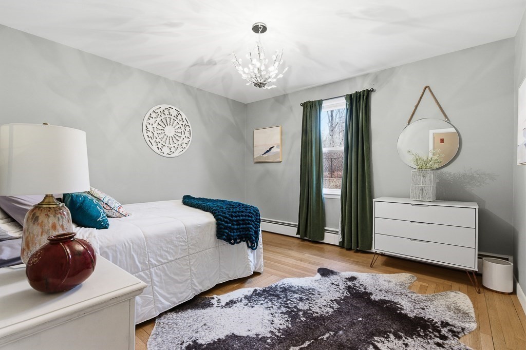 26 Prospect Street Blackstone, MA 01504 - Photo 21 of 41 a bedroom with a bed and a chandelier