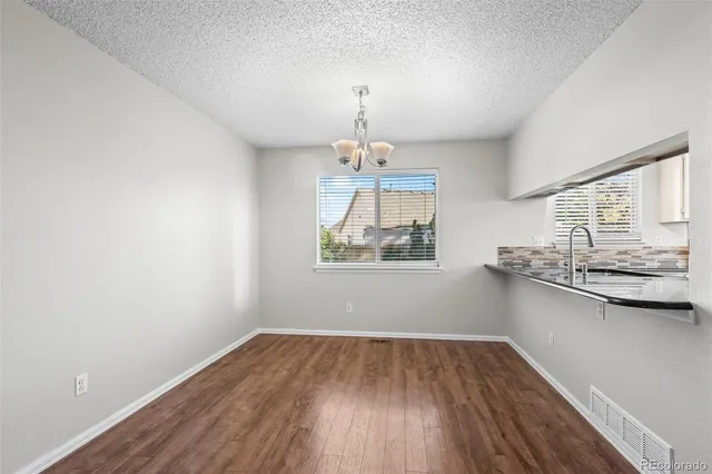 a very nice looking room with wooden floor and a window