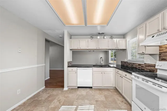 a kitchen with stainless steel appliances a sink stove and cabinets