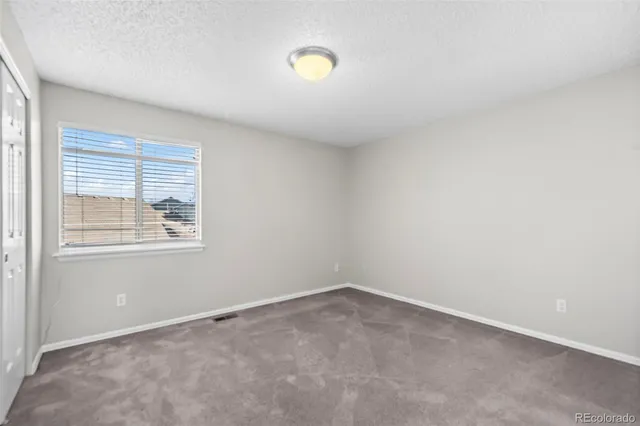 an empty room with windows and window