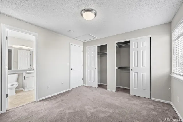 an empty room with closet area