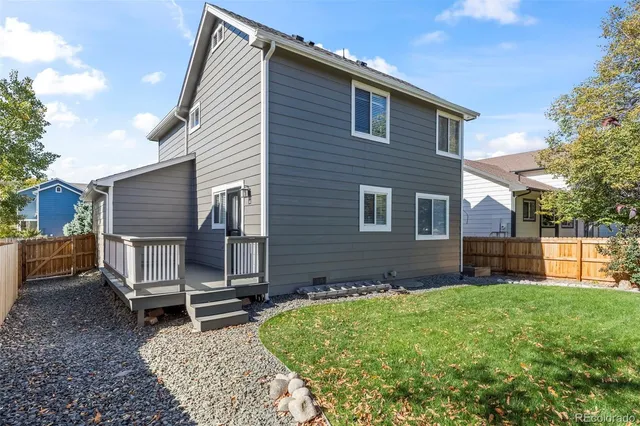 a brick house with a large window and garden view