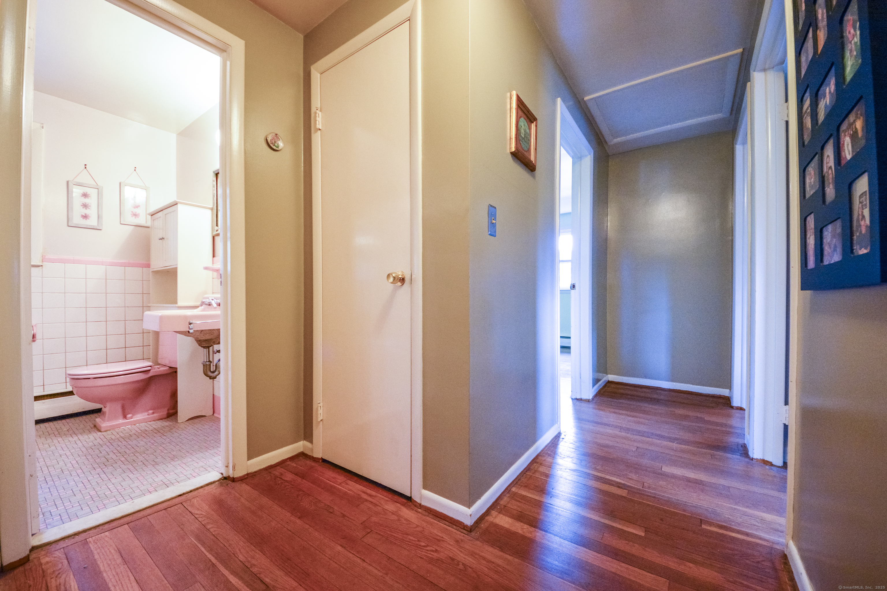 291 Frenchtown Road Bridgeport, CT 06606 - Photo 13 of 40 a view of a hallway with wooden floor and a bathroom