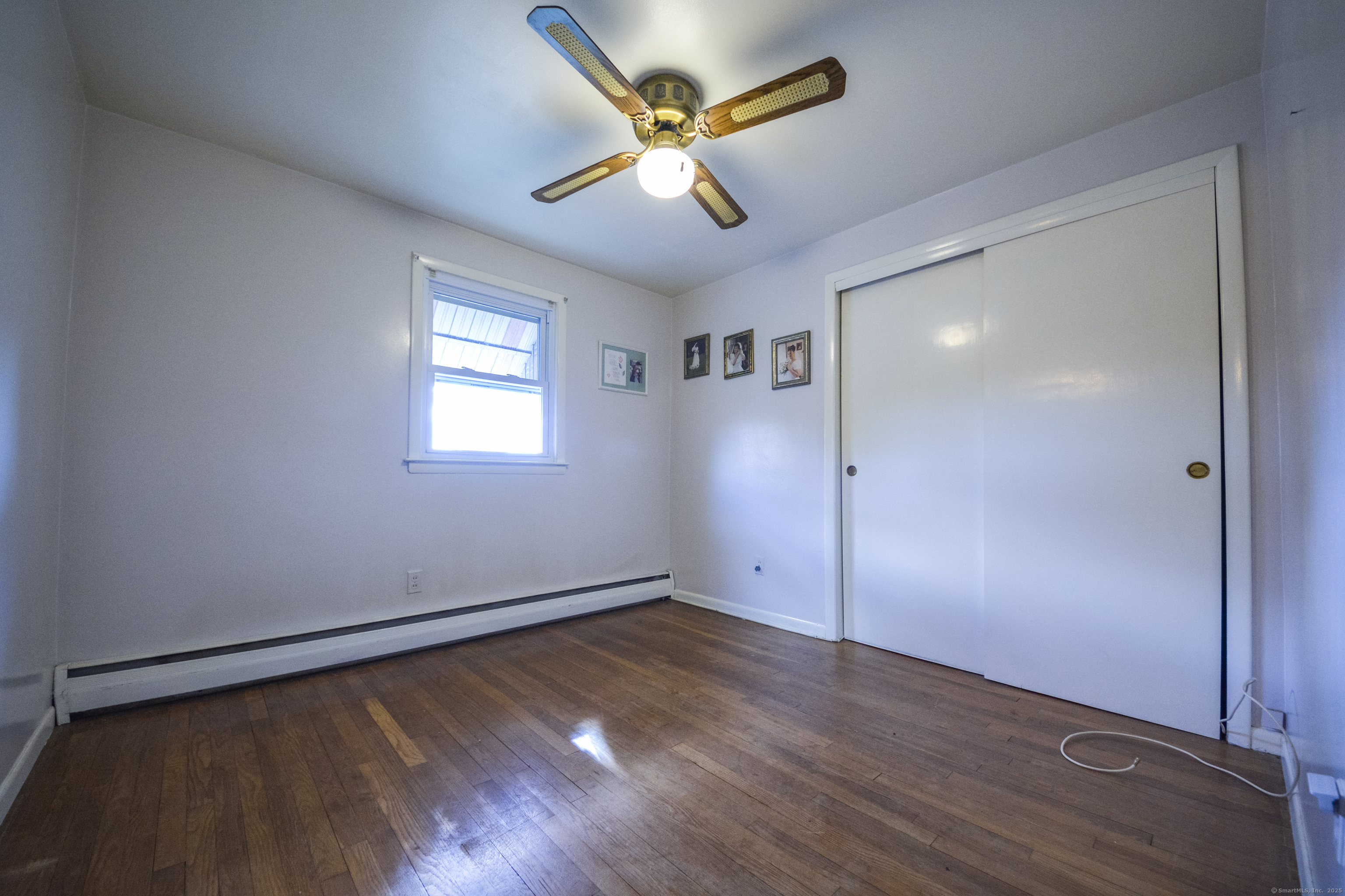 291 Frenchtown Road Bridgeport, CT 06606 - Photo 16 of 40 a view of an empty room with window and wooden floor