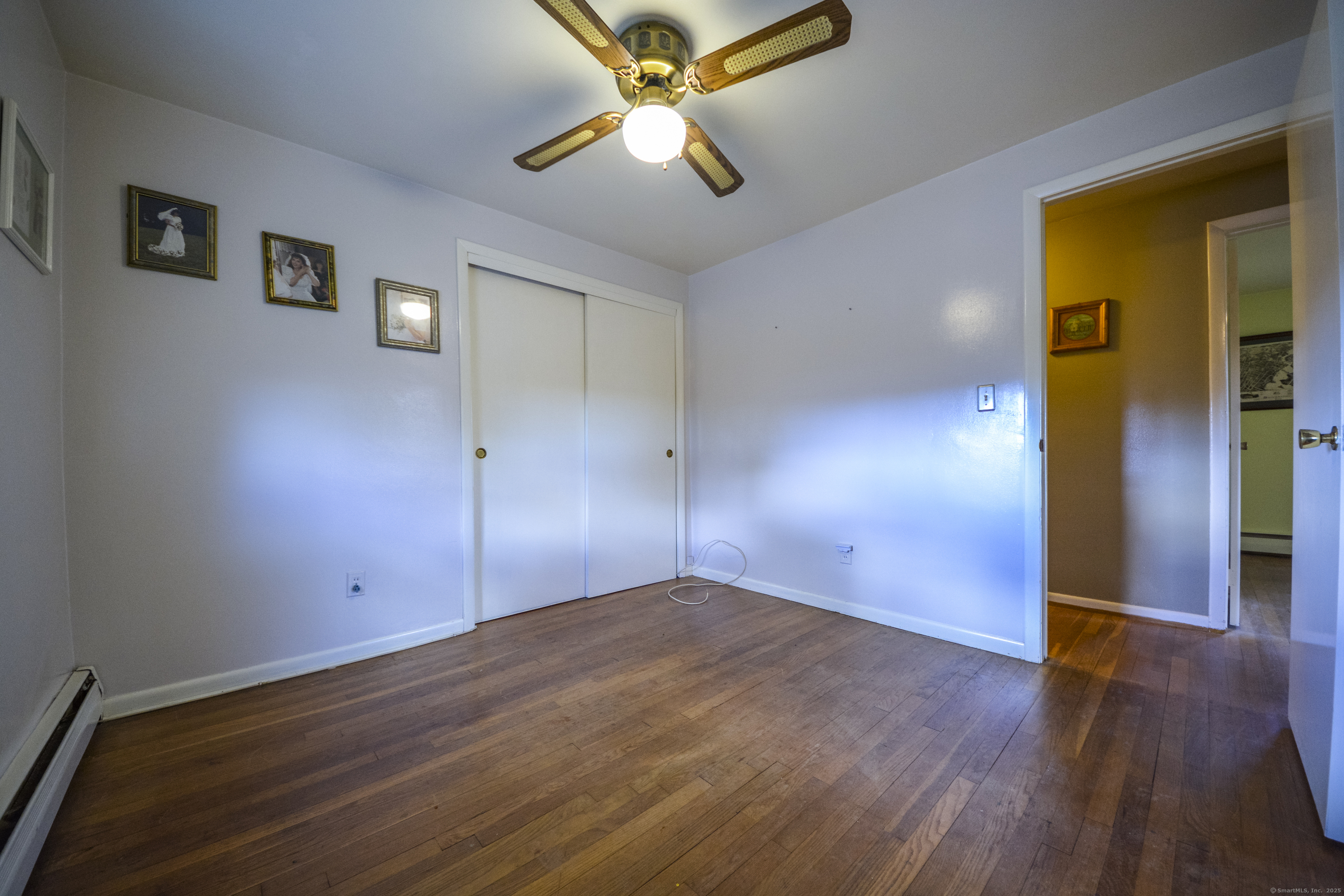 291 Frenchtown Road Bridgeport, CT 06606 - Photo 17 of 40 an empty room with wooden floor and a ceiling fan