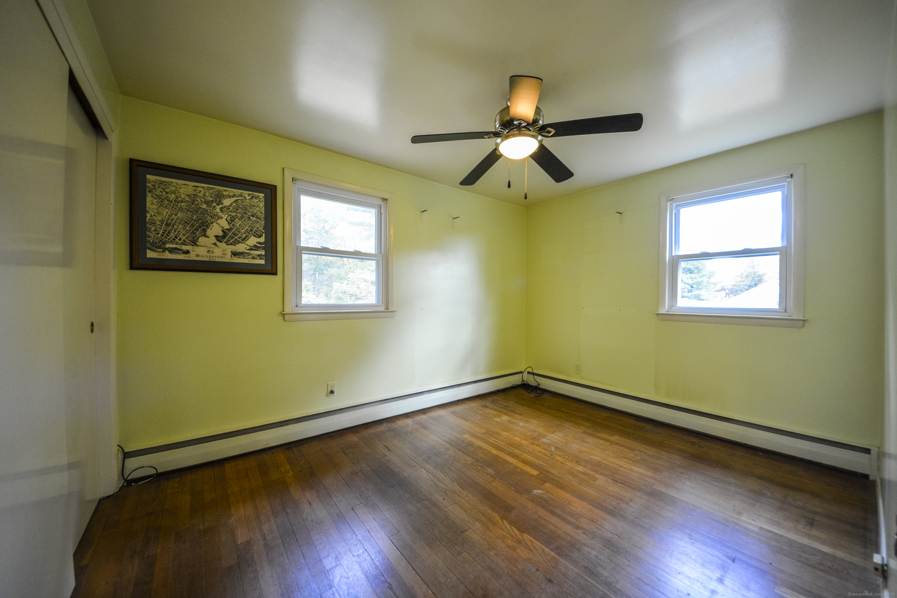 291 Frenchtown Road Bridgeport, CT 06606 - Photo 24 of 40 a view of an empty room with wooden floor and a window