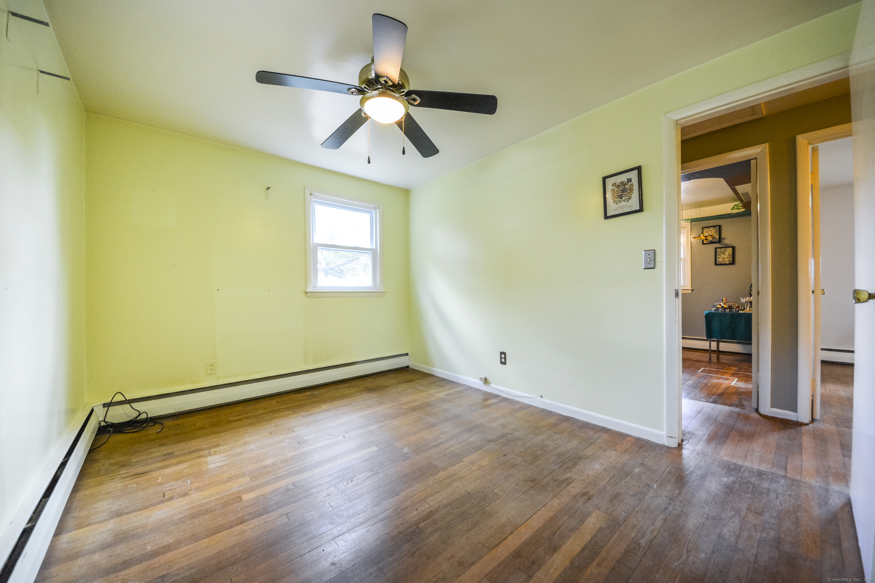 291 Frenchtown Road Bridgeport, CT 06606 - Photo 25 of 40 an empty room with wooden floor fan and windows