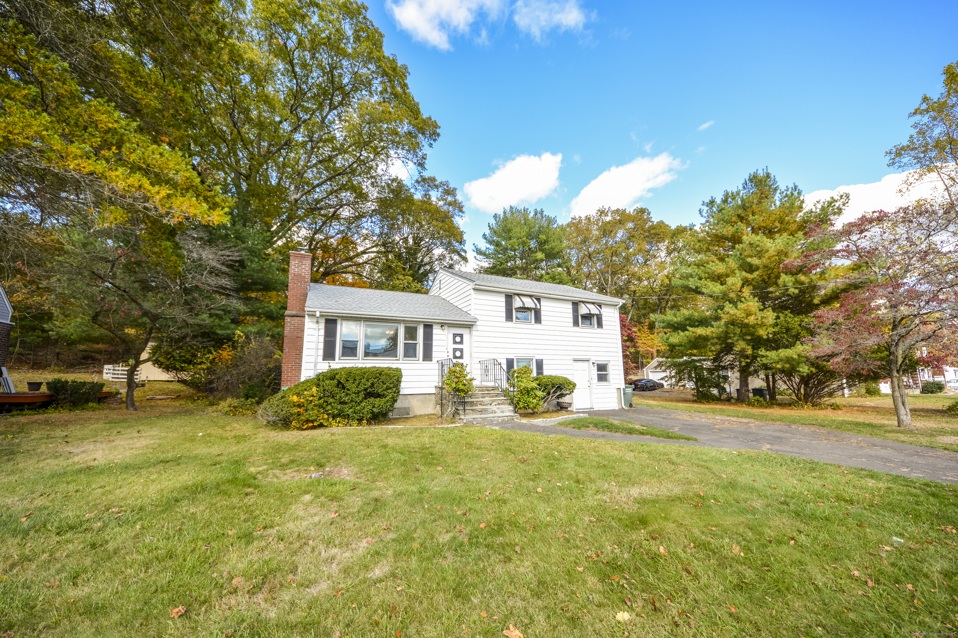 291 Frenchtown Road Bridgeport, CT 06606 - Photo 36 of 40 a front view of a house with a garden and tree