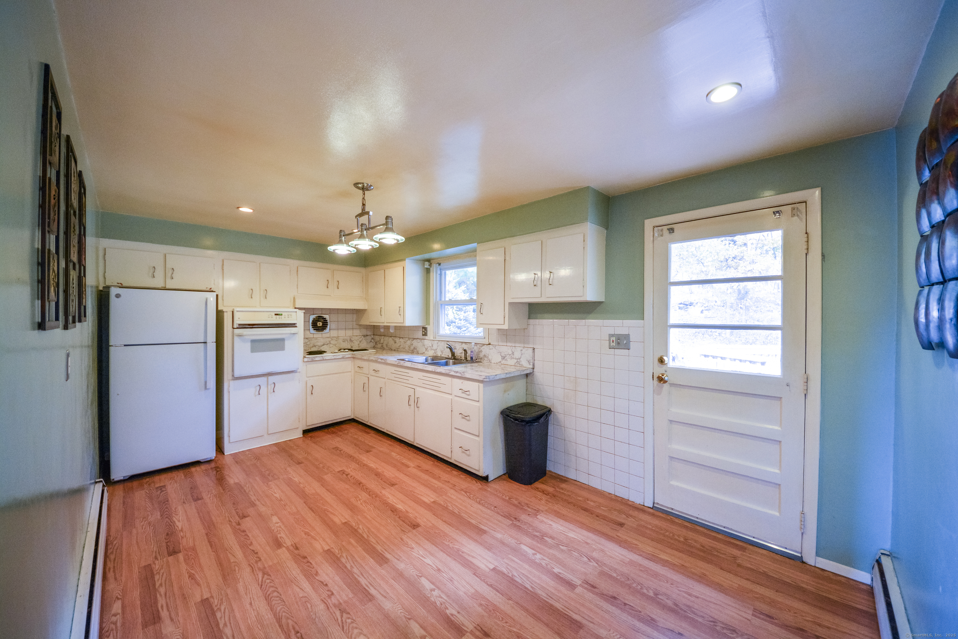 291 Frenchtown Road Bridgeport, CT 06606 - Photo 10 of 40 a kitchen with white cabinets and stainless steel appliances