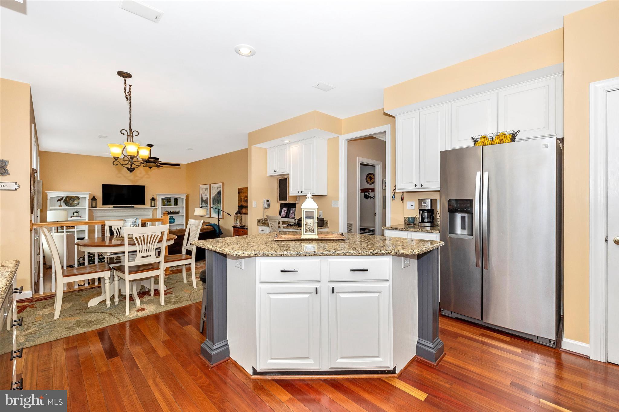 17918 Hickman Street Poolesville, MD 20837 - Photo 14 of 96 a kitchen with stainless steel appliances kitchen island granite countertop a dining table chairs and granite counter tops