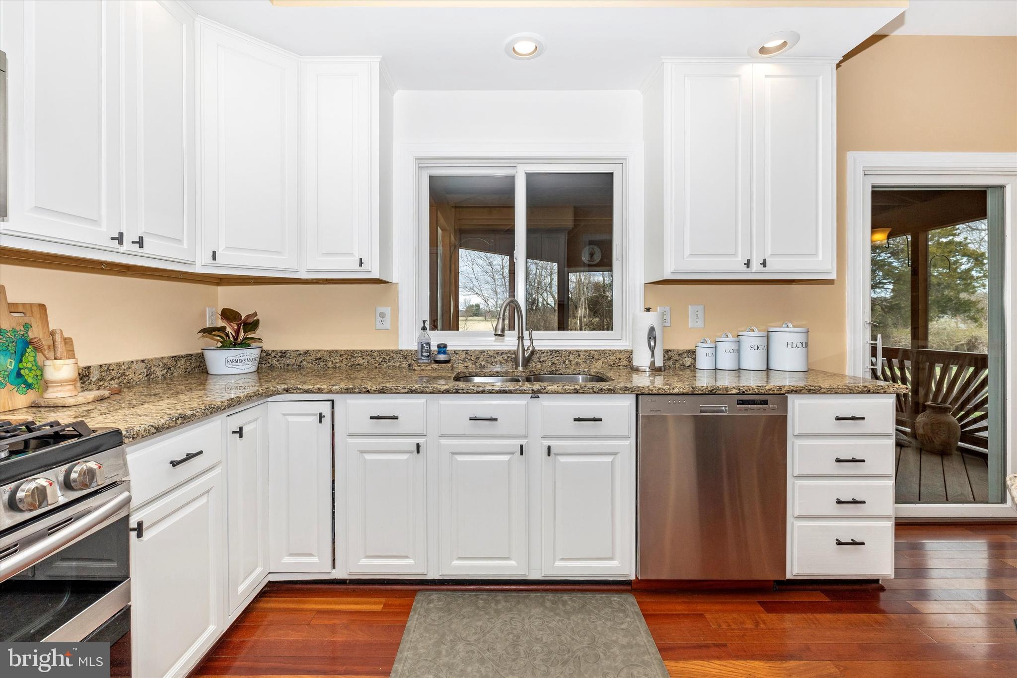17918 Hickman Street Poolesville, MD 20837 - Photo 15 of 96 a kitchen with granite countertop white cabinets and sink