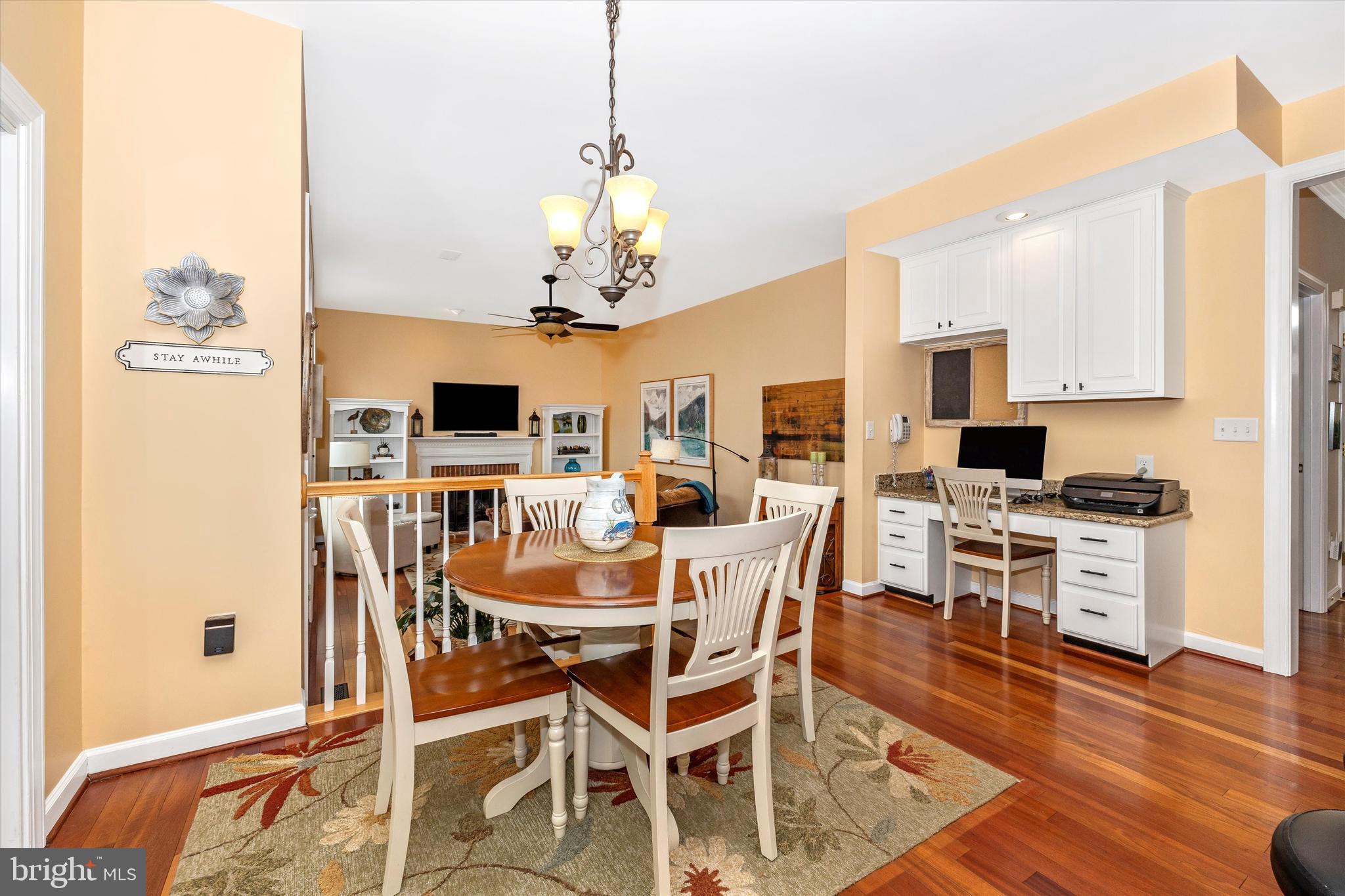 17918 Hickman Street Poolesville, MD 20837 - Photo 17 of 96 a view of a dining room with furniture wooden floor and chandelier