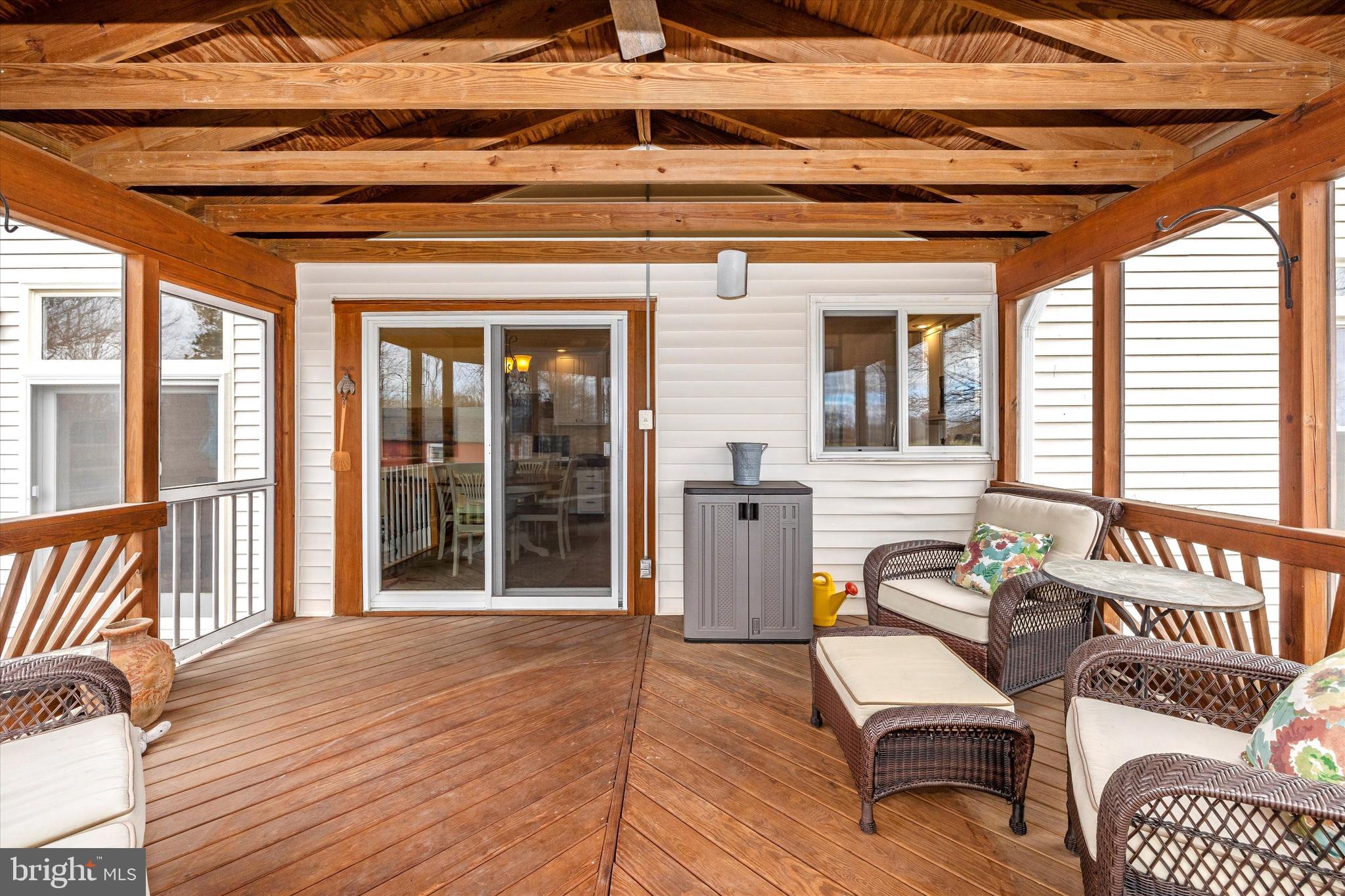 17918 Hickman Street Poolesville, MD 20837 - Photo 23 of 96 a view of a patio with a table and chairs and wooden floor