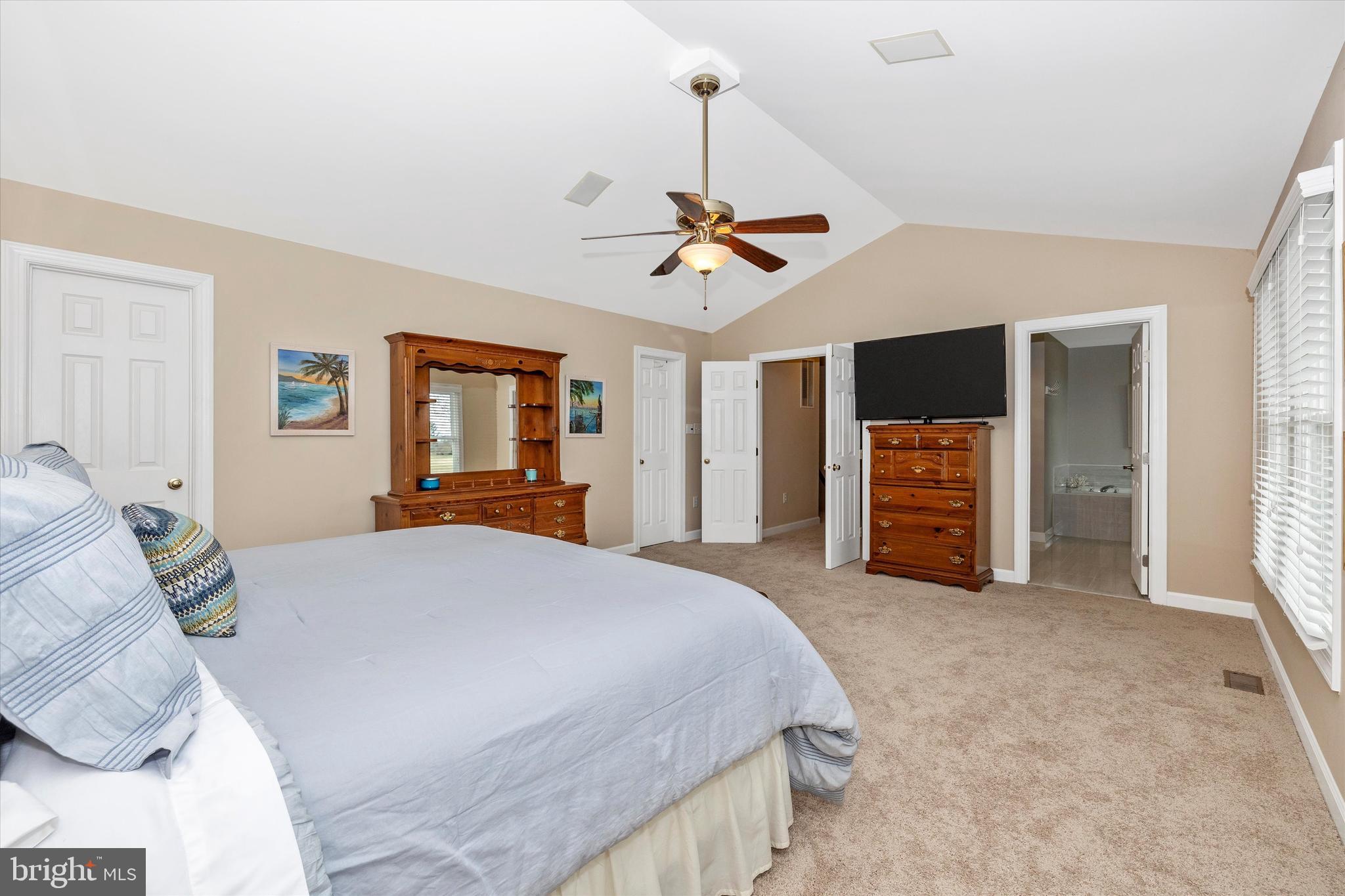 17918 Hickman Street Poolesville, MD 20837 - Photo 30 of 96 a spacious bedroom with a bed and a chandelier