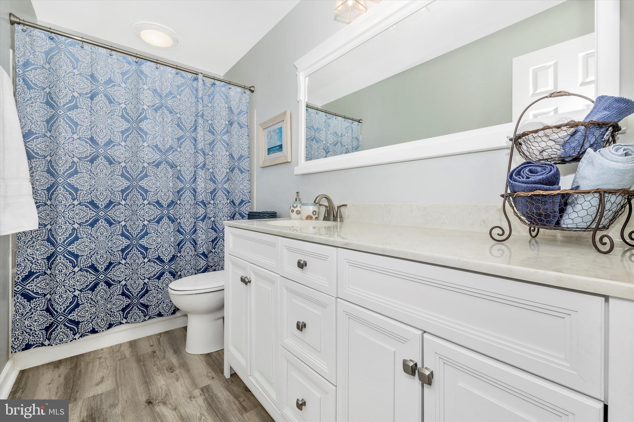 17918 Hickman Street Poolesville, MD 20837 - Photo 39 of 96 a bathroom with a granite countertop toilet sink and mirror