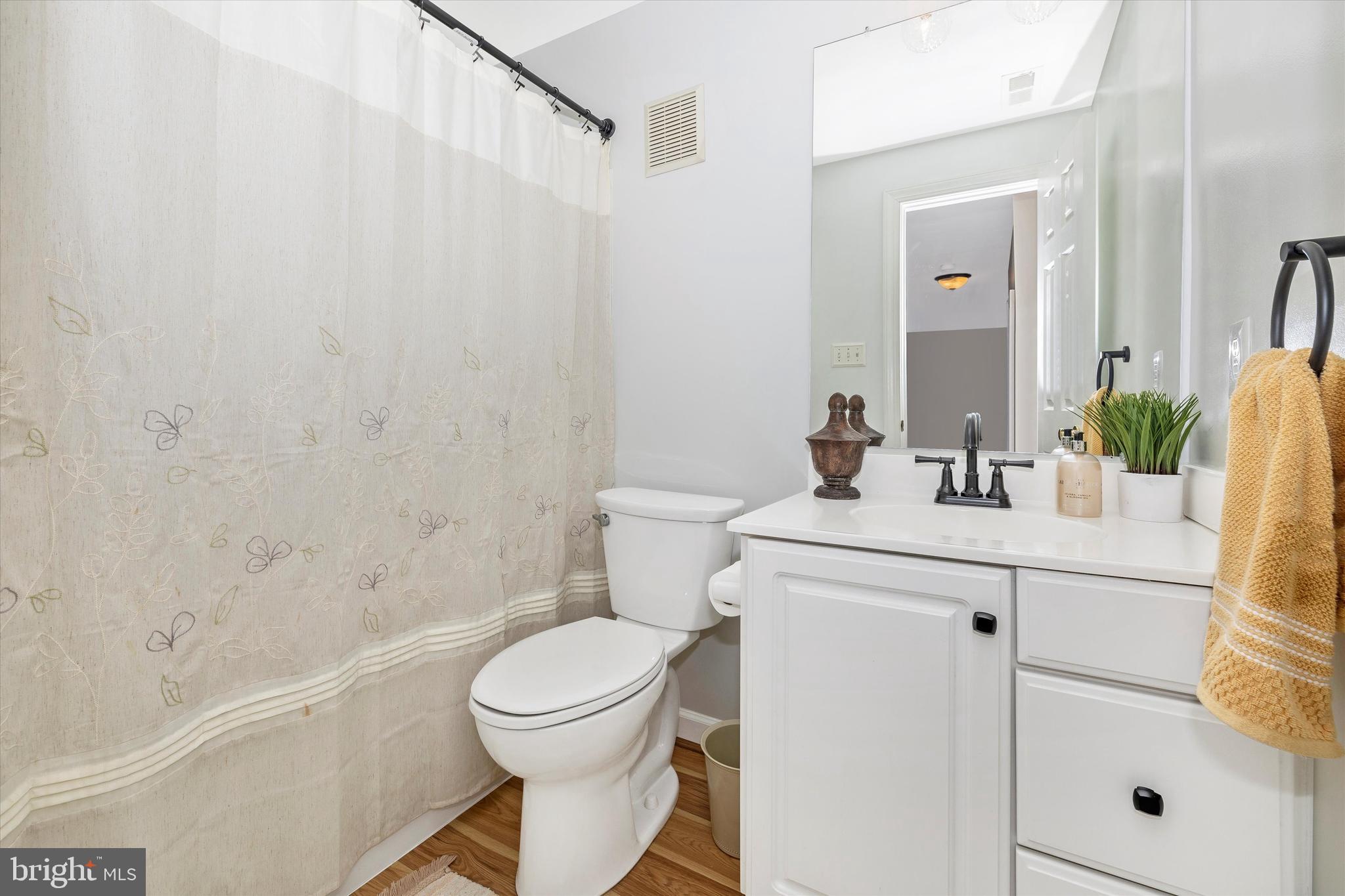 17918 Hickman Street Poolesville, MD 20837 - Photo 47 of 96 a bathroom with a sink a toilet a vanity and shower