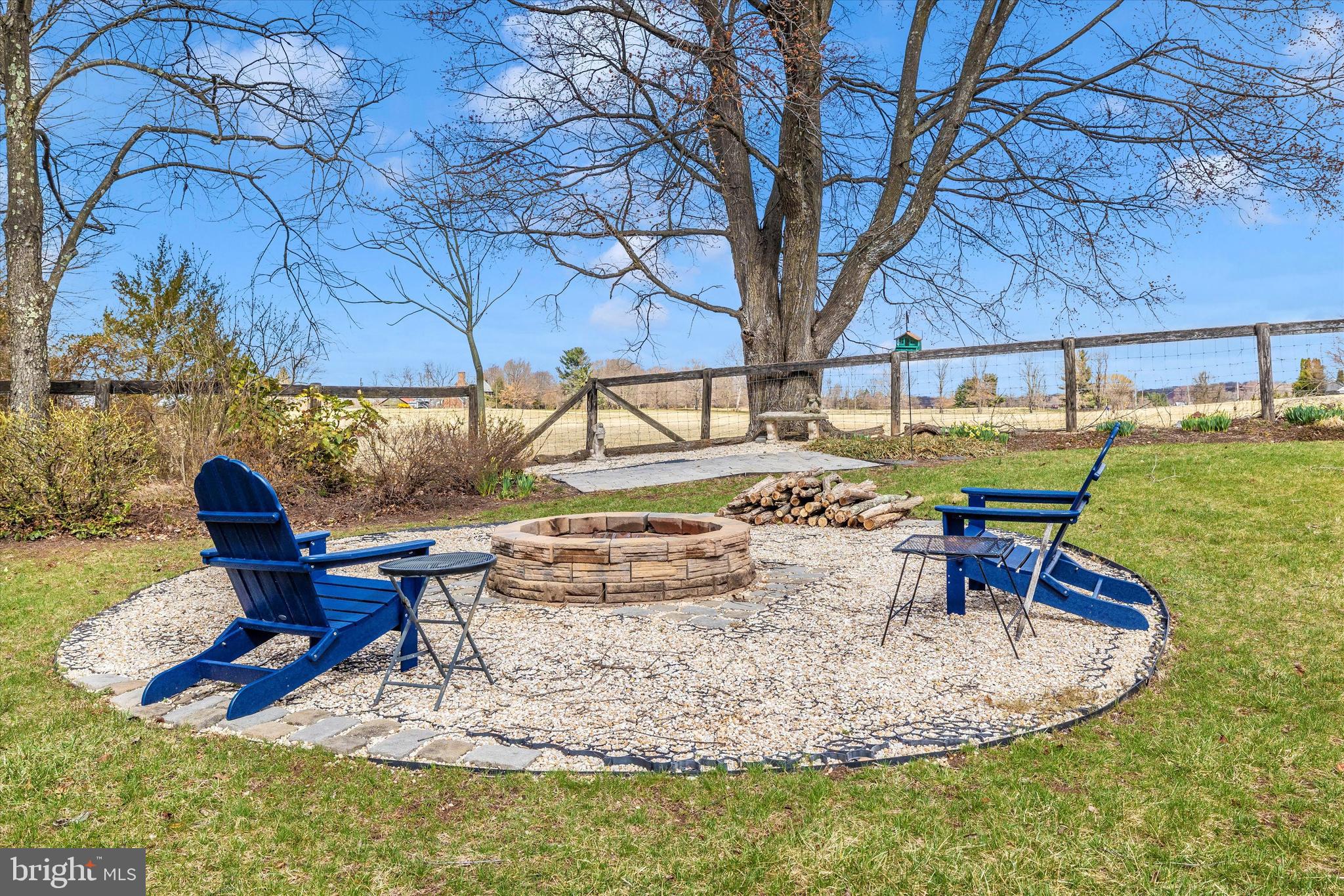 17918 Hickman Street Poolesville, MD 20837 - Photo 54 of 96 a view of a backyard with table and chairs under an umbrella