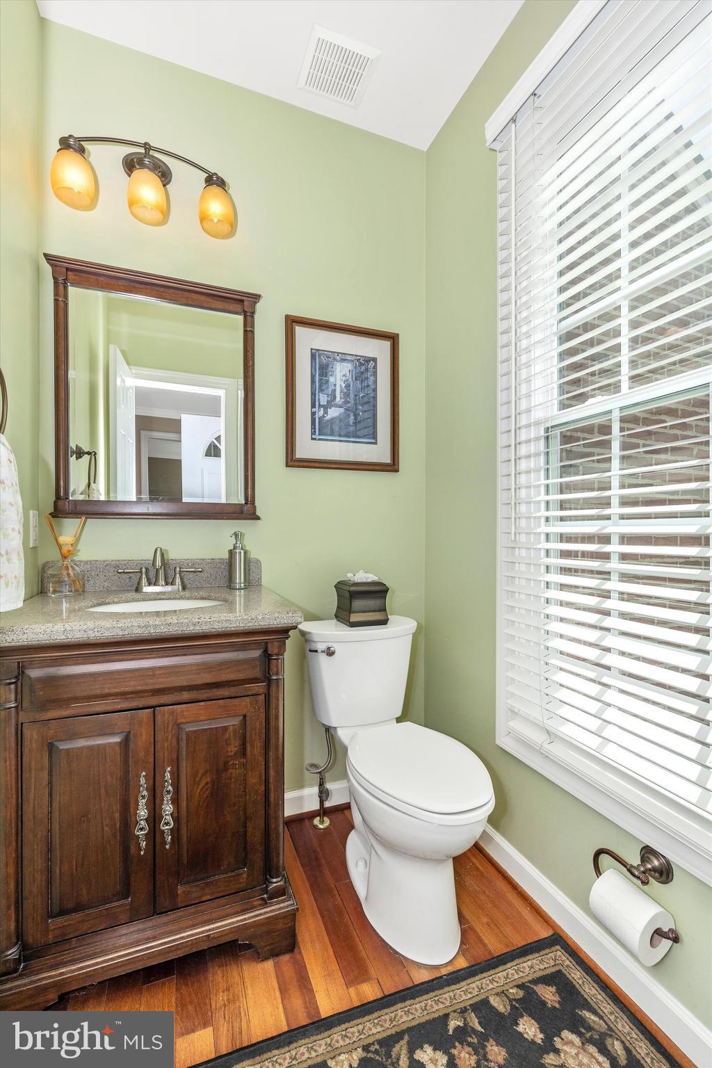 17918 Hickman Street Poolesville, MD 20837 - Photo 10 of 96 a bathroom with a toilet a sink and a mirror