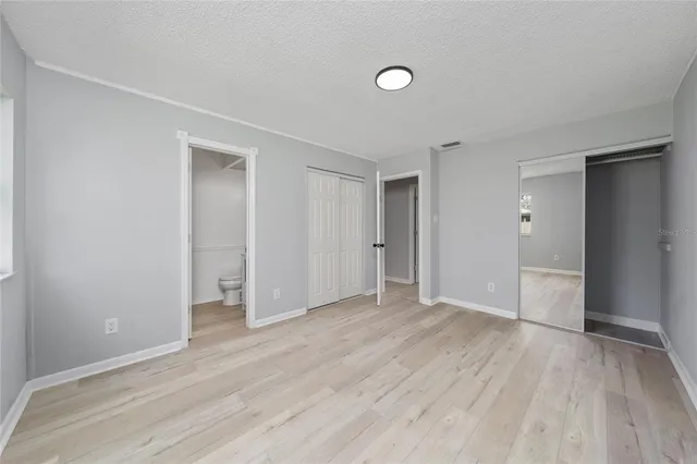 a view of an empty room and wooden floor