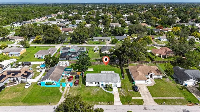 an aerial view of residential houses with outdoor space and street view