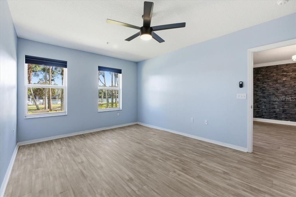 100 Canopy Walk Lane, Unit 112 Palm Coast, FL 32137 - Photo 20 of 62 a view of an empty room with window and wooden floor