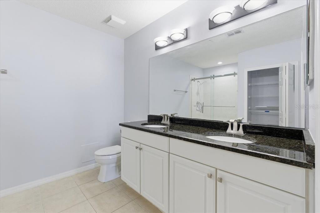 100 Canopy Walk Lane, Unit 112 Palm Coast, FL 32137 - Photo 23 of 62 a bathroom with a granite countertop sink and a mirror
