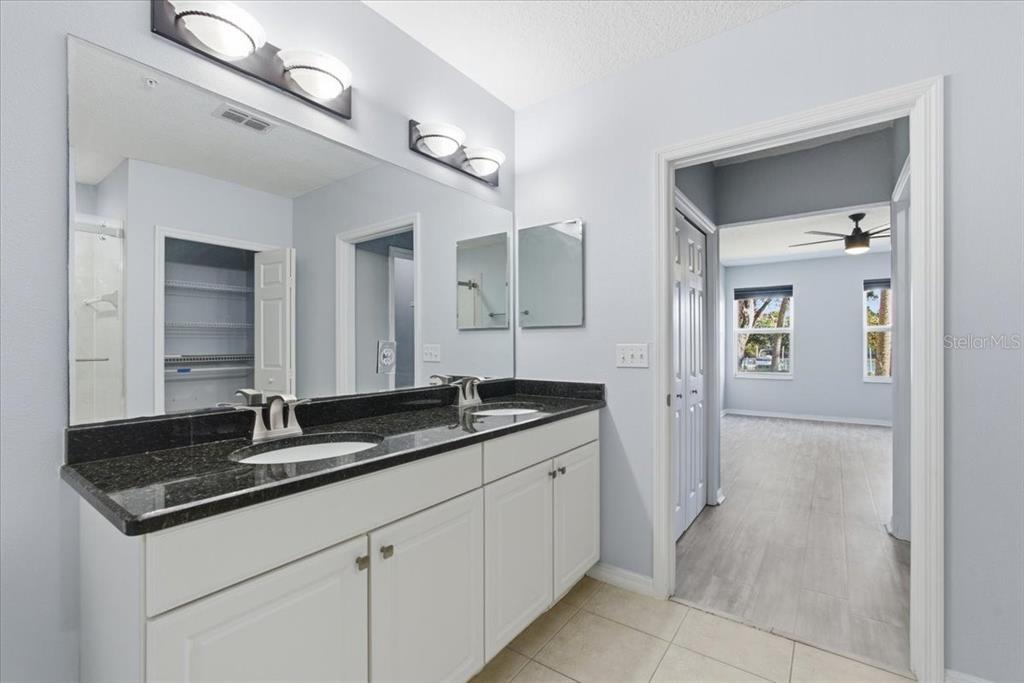 100 Canopy Walk Lane, Unit 112 Palm Coast, FL 32137 - Photo 24 of 62 a bathroom with a granite countertop sink and a mirror