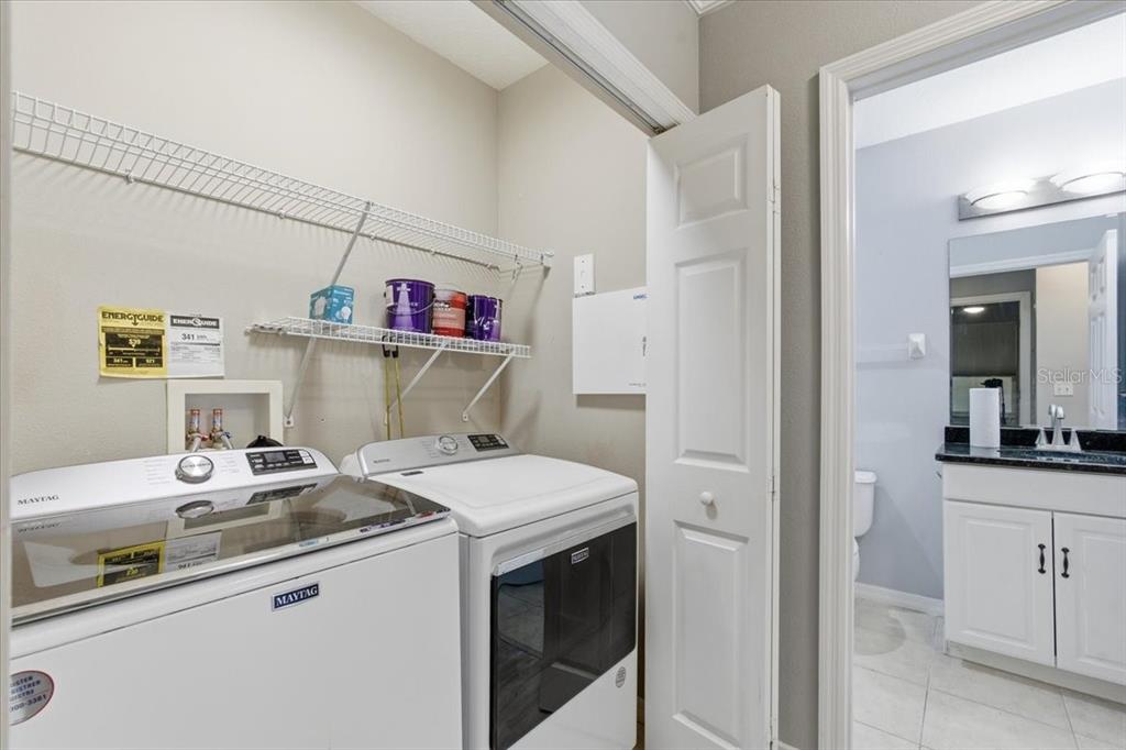 100 Canopy Walk Lane, Unit 112 Palm Coast, FL 32137 - Photo 30 of 62 a utility room with a sink dryer and washer