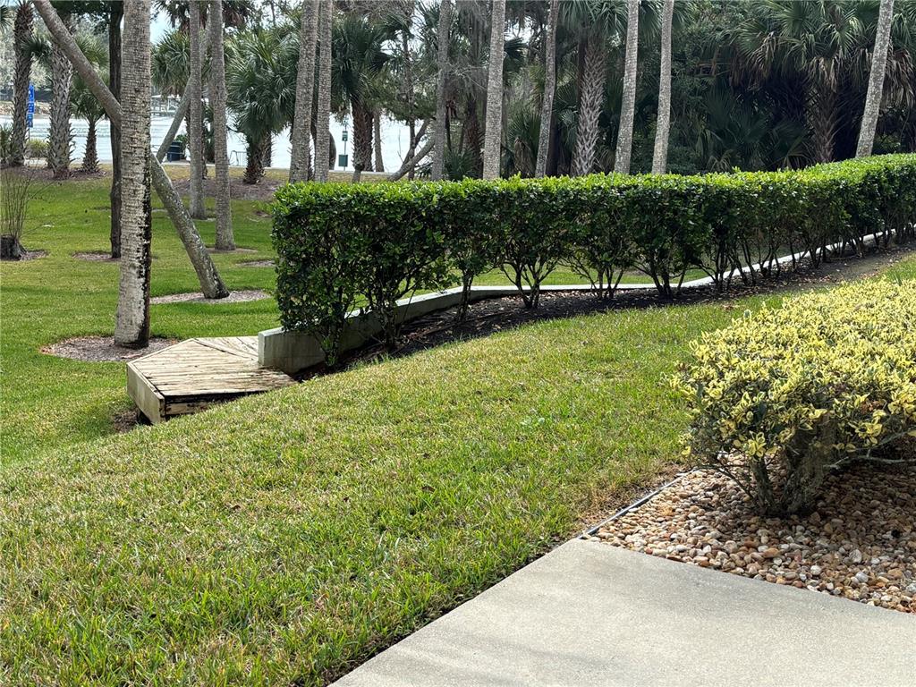 100 Canopy Walk Lane, Unit 112 Palm Coast, FL 32137 - Photo 44 of 62 a view of a garden with a bench