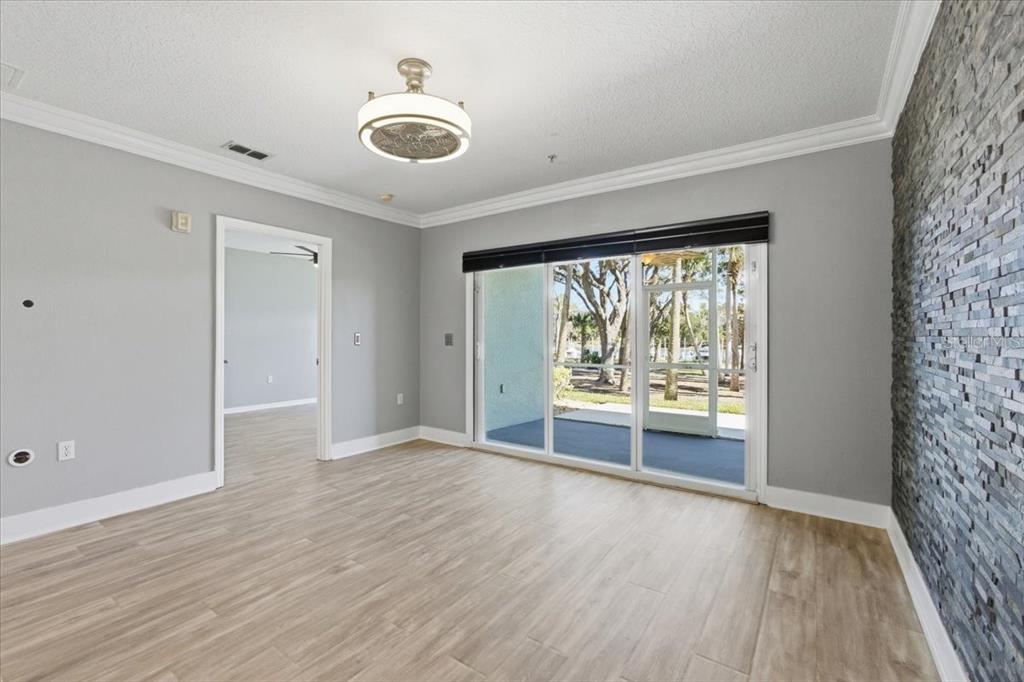 100 Canopy Walk Lane, Unit 112 Palm Coast, FL 32137 - Photo 6 of 62 wooden floor in an empty room with a window