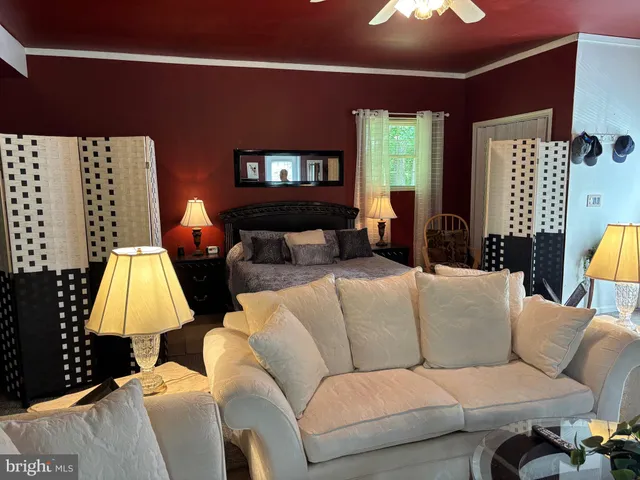 a living room with furniture and a lamp