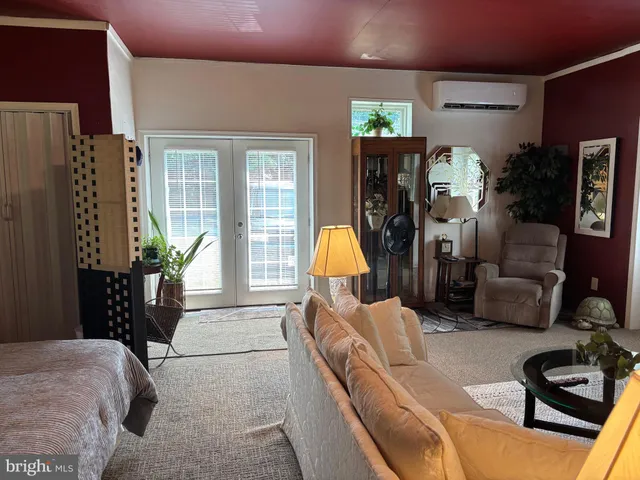 a living room with furniture and a lamp