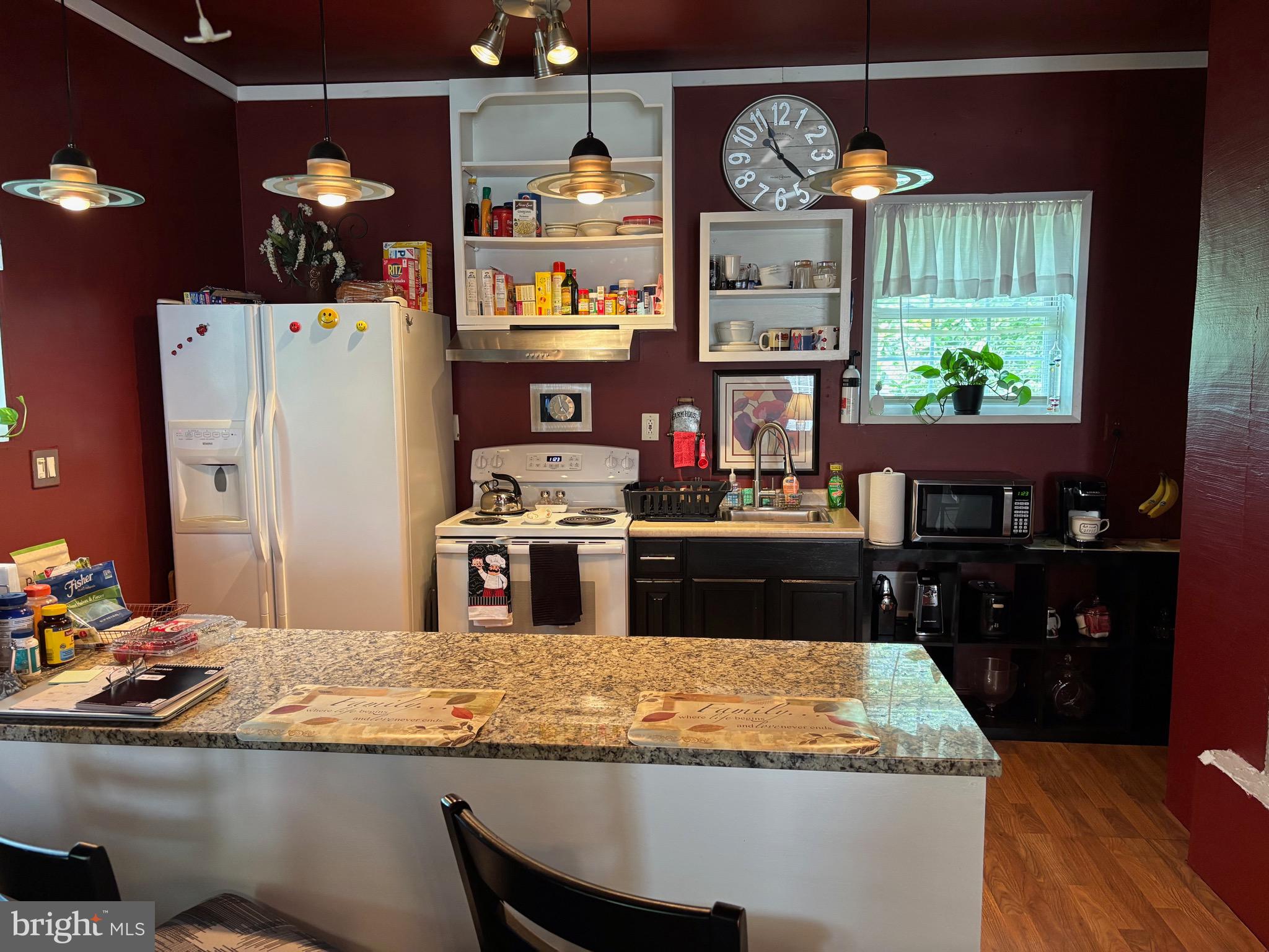 579 Leeland Road Fredericksburg, VA 22405 - Photo 20 of 20 a kitchen with kitchen island granite countertop a sink stainless steel appliances and a counter top space