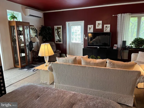 a living room with furniture a lamp and a flat screen tv