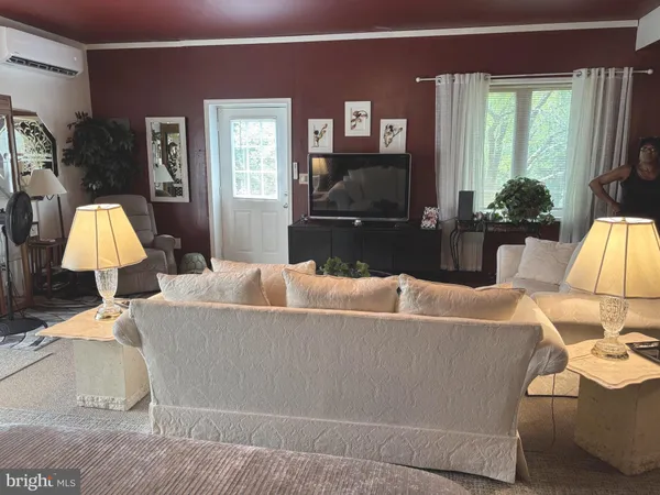 a living room with furniture and a flat screen tv