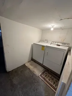 a kitchen with a stove a table and chairs in it
