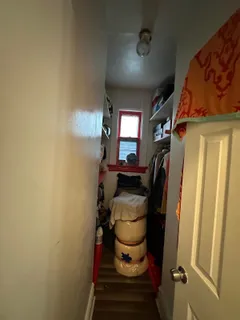 a bed room with furniture and a mirror