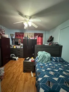 a bed sitting in a bedroom next to a window