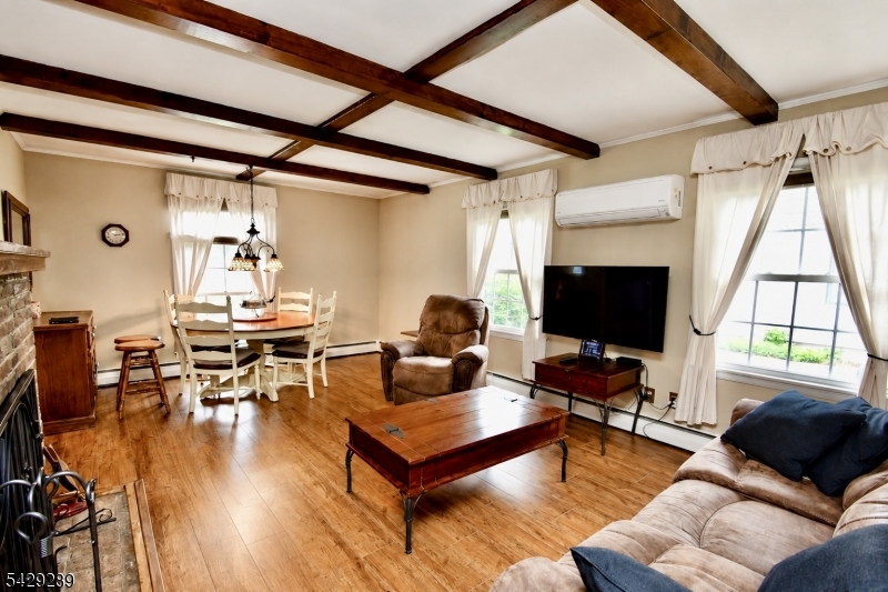 16 Pequot Trail Oak Ridge, NJ 07438 - Photo 4 of 18 a living room with furniture a flat screen tv and a window