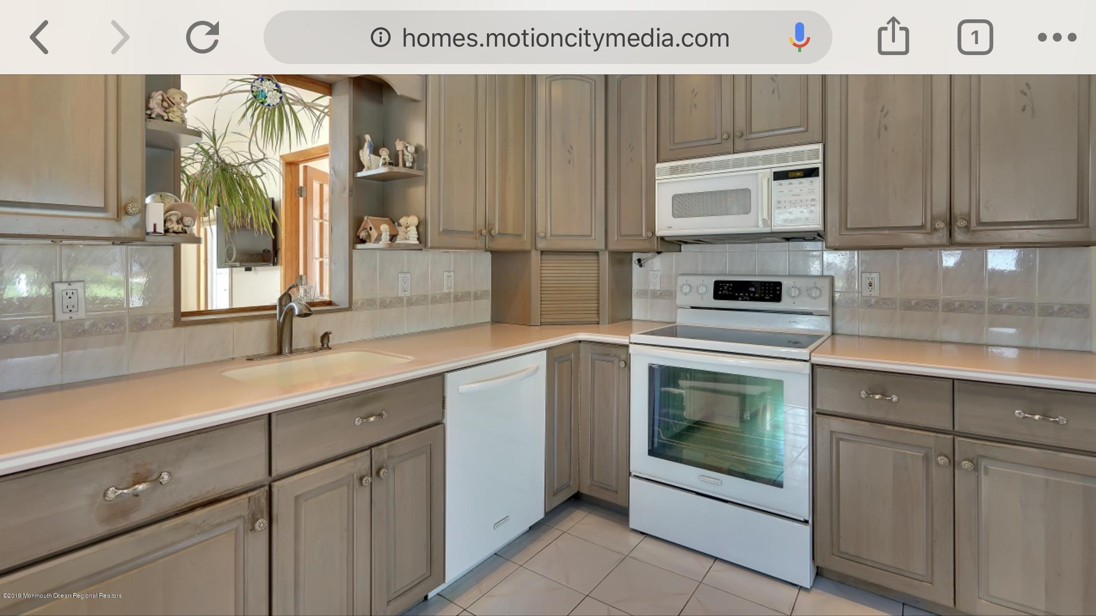 40 Cedar Run Road Bayville, NJ 08721 - Photo 4 of 12 a kitchen with cabinets and white appliances