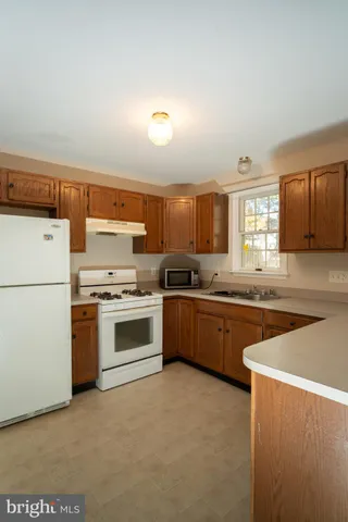 a kitchen with stainless steel appliances granite countertop a stove and a refrigerator