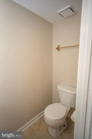 a white toilet sitting next to a shower