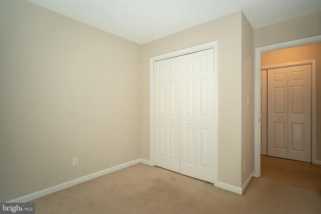 an empty room with closet area