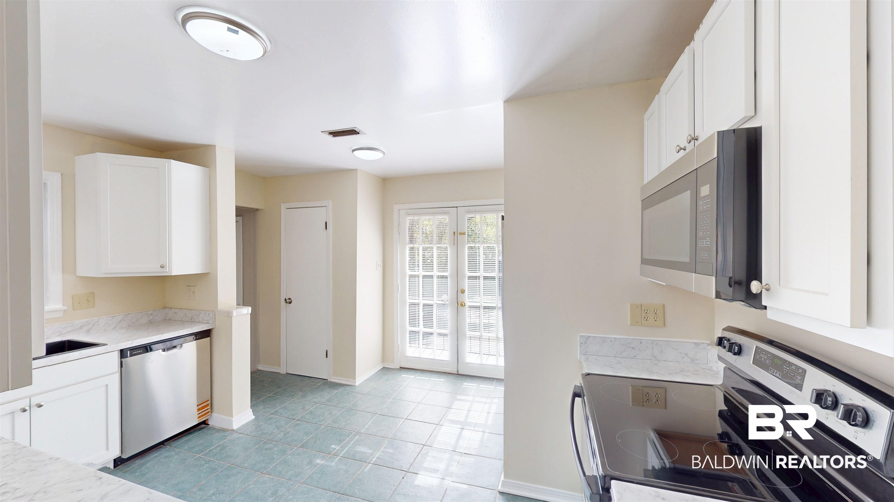 1471 Cedar Crescent Drive Mobile, AL 36605 - Photo 8 of 28 Kitchen featuring stainless steel appliances, white cabinets, light tile patterned floors, and french doors